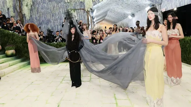 Madonna with women holding her long dress train