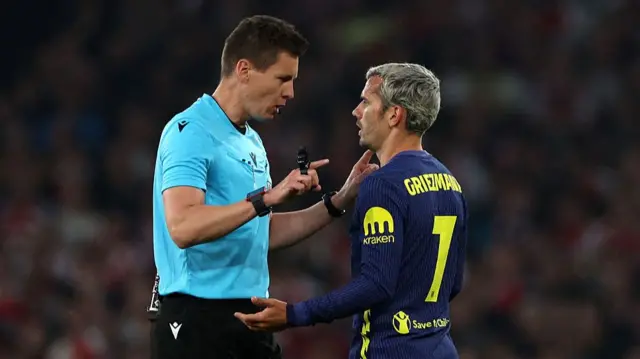 Griezman in conversation with a referee