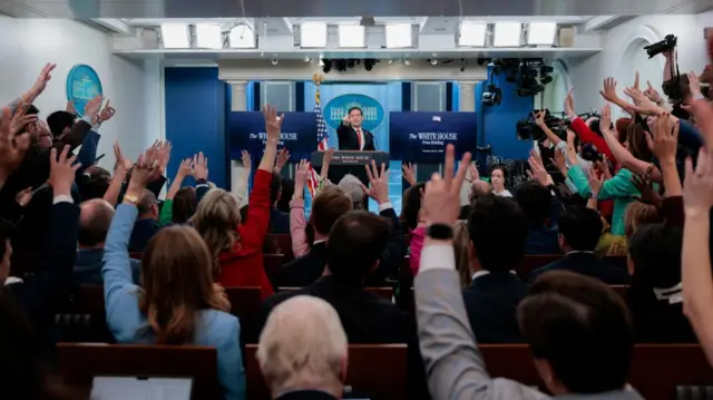 A crowd with hands up looking at Rubio.