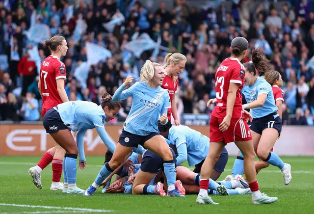 Man City players crowd Knaak after her late winner