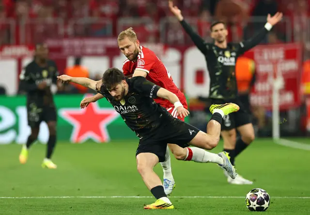 Konrad Laimer of Bayern Munich competes with Khvicha Kvaratskhelia of Paris Saint-Germain