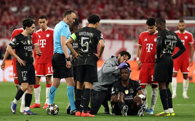 Paris Saint-Germain's Ecuadoran defender #51 Willian Pacho (4R bottom) receives medical treatment