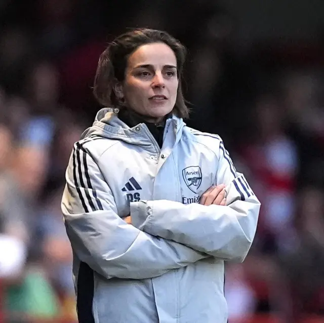 Slegers stands with her arms crossed