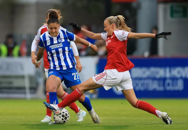 Maanum tackles a Brighton player in midfield