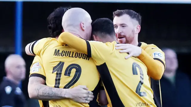 Luke McCullough celebrates his equaliser with his Carrick Rangers team-mates