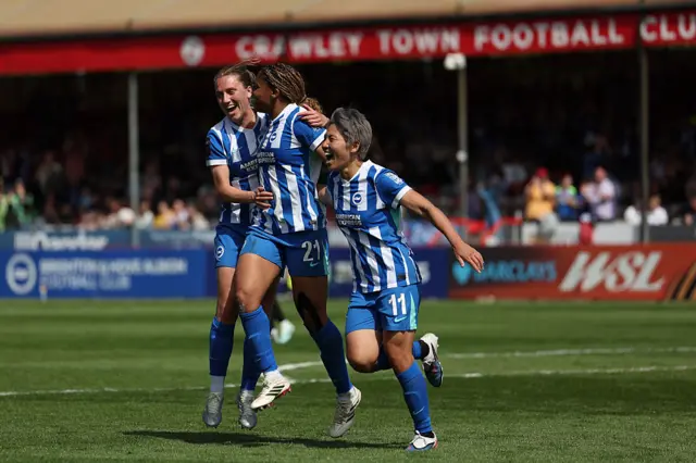 Brighton women celebrate a goal v Man City