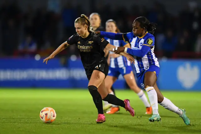 Carter tackles Pelova when playing for Brighton v Arsenal