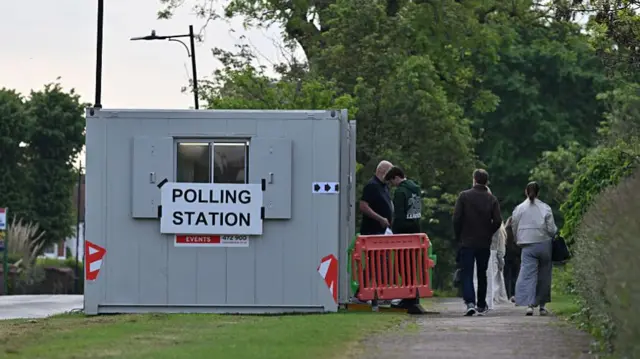 People arrive early morning to vote at a portable polling station for today's UK local elections on May 07, 2026 in Leigh on Sea, England.