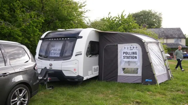 A caravan which is being used as a polling station opens up for voters in Duxford, Cambridgeshire.