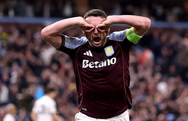 McGinn does his iconic goggles celebration after scoring