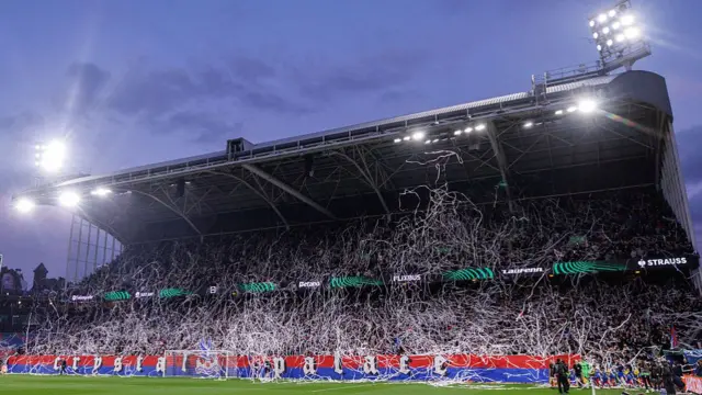 Players walk out as they are covered in ticker tape