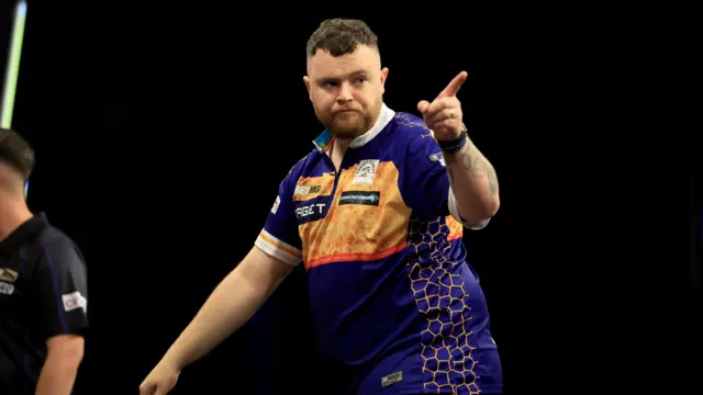 Josh Rock during his match against Luke Humphries on night fourteen of the BetMGM Premier League 2026 at First Direct Bank, Leeds