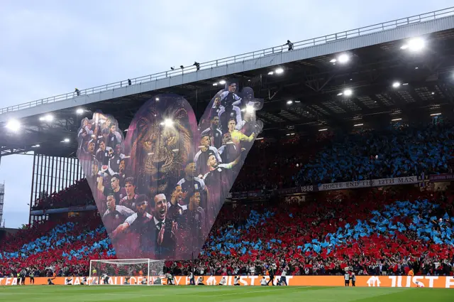 Tifo in the holte end of a huge heart with the players and Villa Lion inside