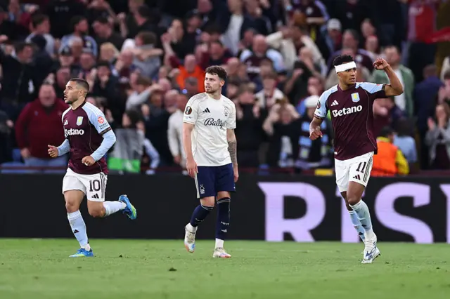 Villa players run back to kick off after taking the lead as Forest players look disheartened