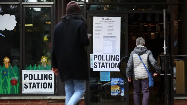Voters enter a polling station during local elections in London