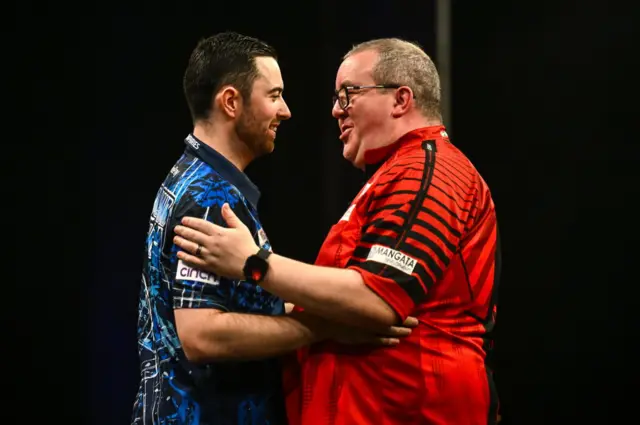 Luke Humphries (left) embraces Stephen Bunting (right)