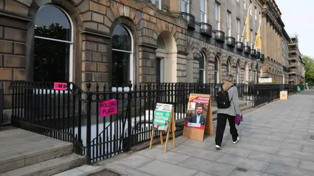 A person walks past a polling station in Edinburgh