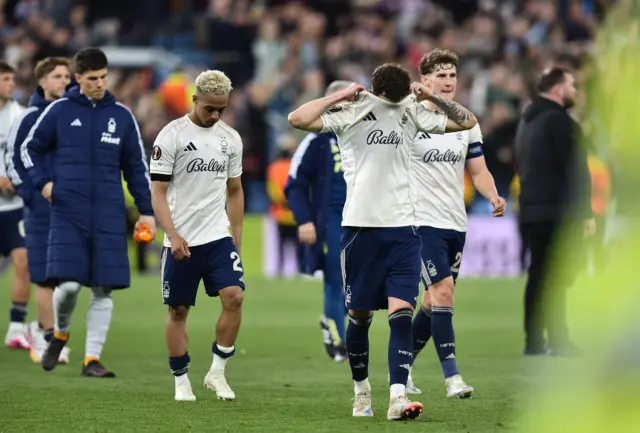 Forest players put shirts over their faces as they head to thank the travelling fans