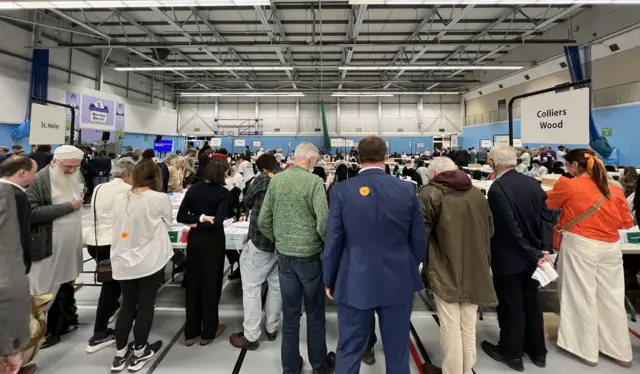 Back of people looking at vote counters