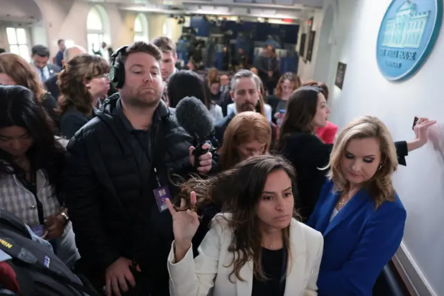 Reporters wait in hallway