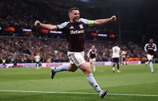 McGinn celebrates scoring the third