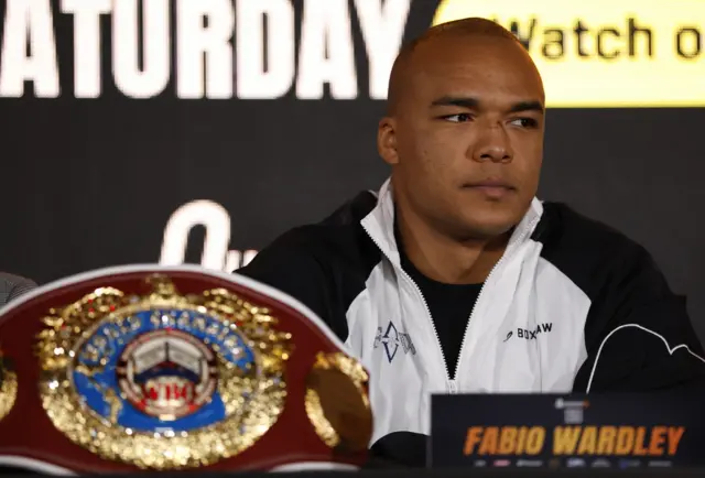Fabio Wardley at a news conference, with his belt in front of him