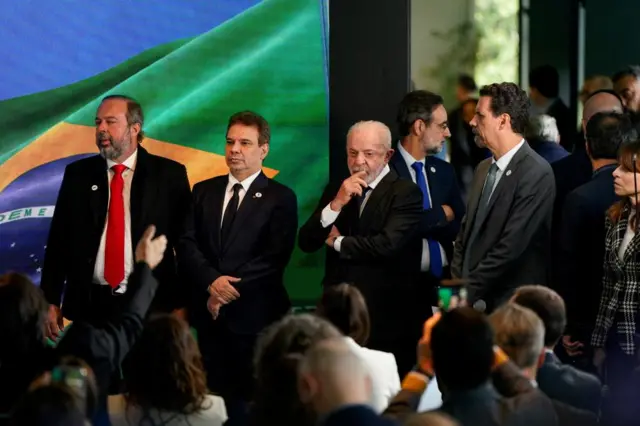 Presdient Lula of Brazil and Brazilian ministers stand in a line before reporters
