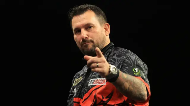 Jonny Clayton reacts during his match against Luke Littler on night fourteen of the BetMGM Premier League 2026 at First Direct Bank, Leeds