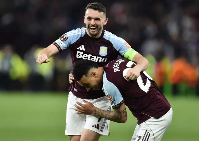 McGinn and Rogers hug to celebrate at full time