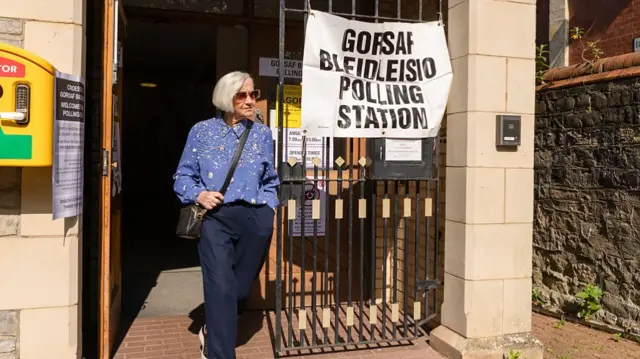 A woman walking out of a polling station