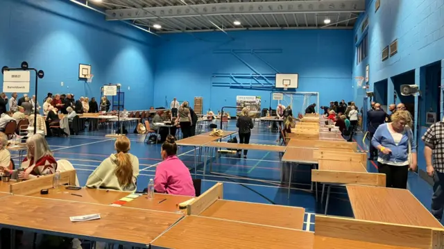 Tables in an hall being used for an election count