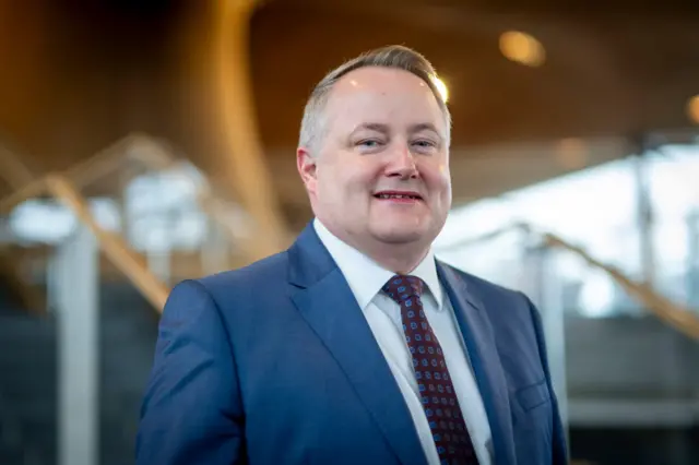 darren Millar at the Senedd in navy suit
