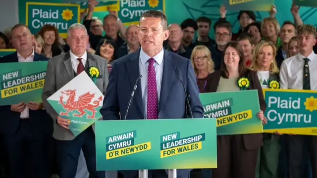 Rhun ap Iorwerth makes a speech in front of cheering supporters