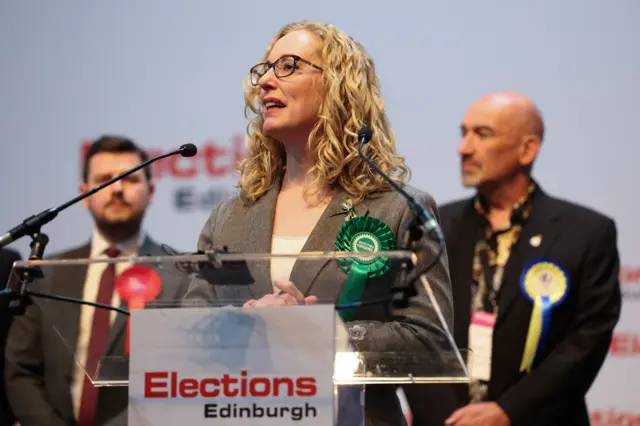 Lorna Slater standing at a podium.