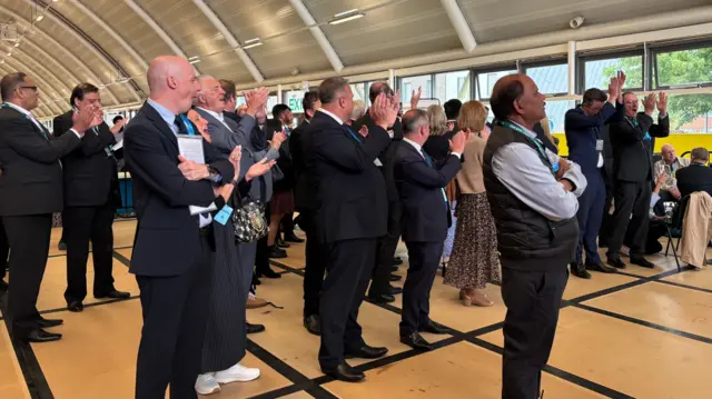 Campaigners stand in a hall