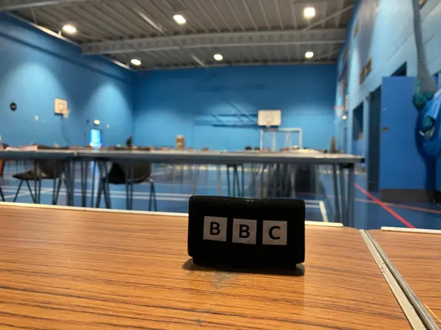empty sports hall with desks and chairs.
