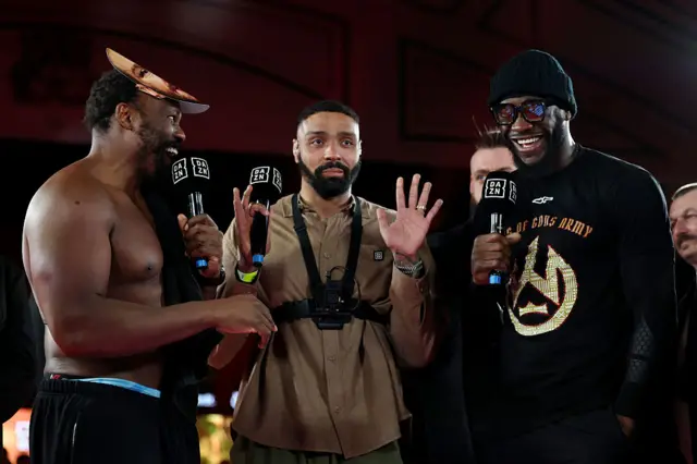 Derek Chisora and Deontay Wilder with microphones