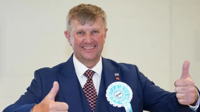 Reform UK candidate Peter Harris reacts after being named councillor for Clacton North during the 2026 Essex County Council election at Clacton Leisure Centre in Essex