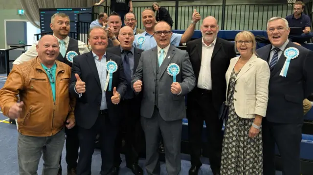 Reform UK party representatives posing for a picture during Cherwell District Council count.