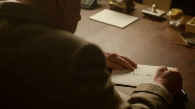 The King pictured writing a letter for Attenborough