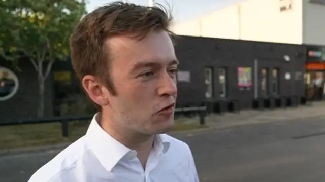 Labour MP Tom Rutland giving an interview in a car park