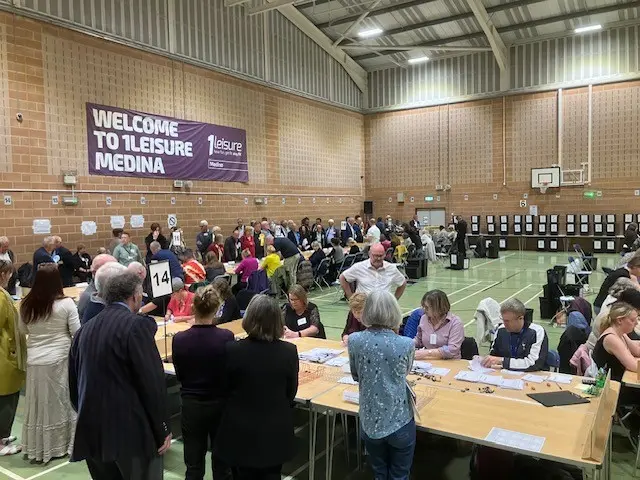 The count for Isle of Wight votes at 1Leisure Medina. Some people are sitting while many are standing up.