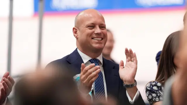 Dan Thomas claps during the Senedd election count