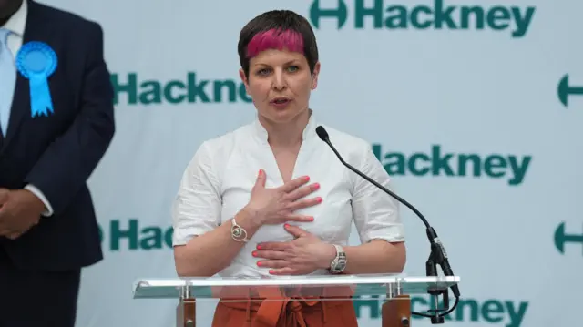 Zoe Garbett speaking at lecturn