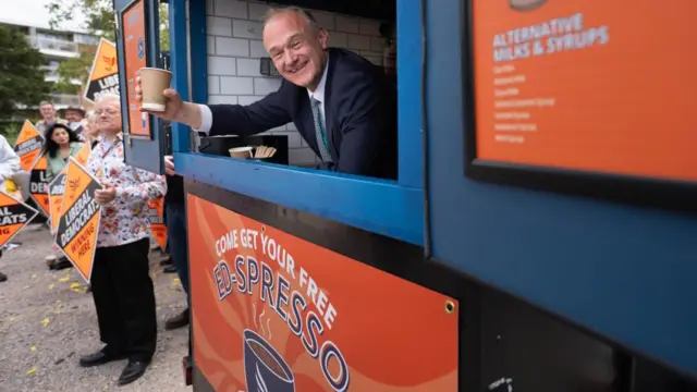 Liberal Democrat leader Sir Ed Davey serves coffee as a thank you to party campaigners and activists at Guildfordians Rugby Football Club in Guildford, Surrey