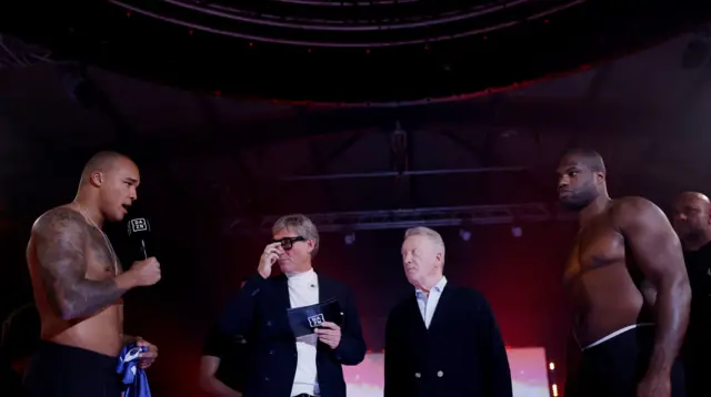 Fabio Wardley speaks into a microphone as he stands across from Daniel Dubois