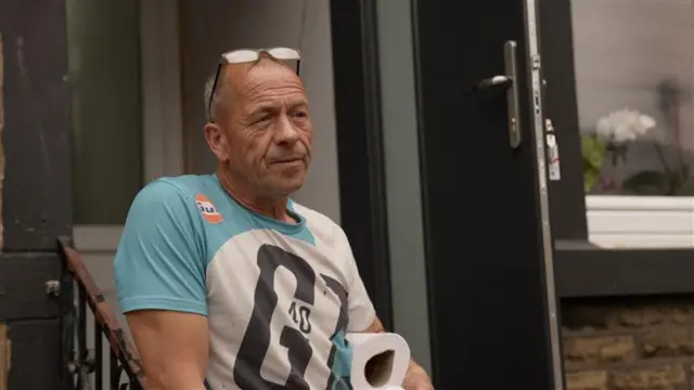 A man in a light blue t-shirt