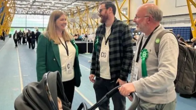 Gillian Mackay with her husband, father and baby in a pram at election count