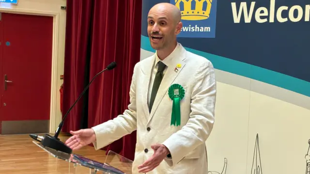 Liam Shrivastava speaking at a podium.