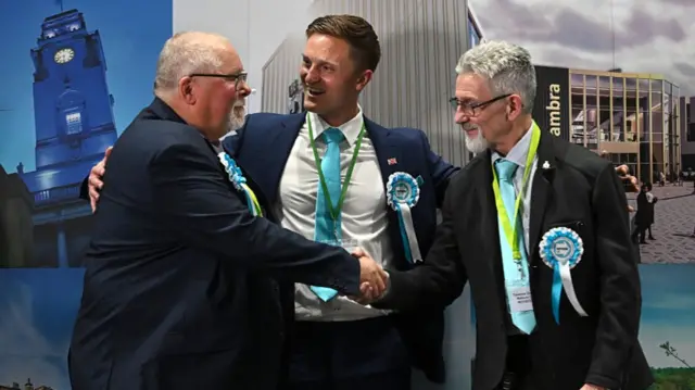 Three Reform UK candidates congratulate each other
